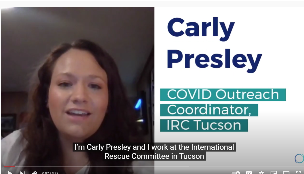 A screenshot of a video. The screenshot shows a woman, with the caption “I am Carly Preston, and I work at the International Rescue Committee at Tucson. 