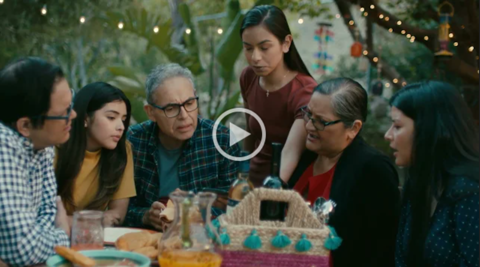 Scene from a video showing a family around a table