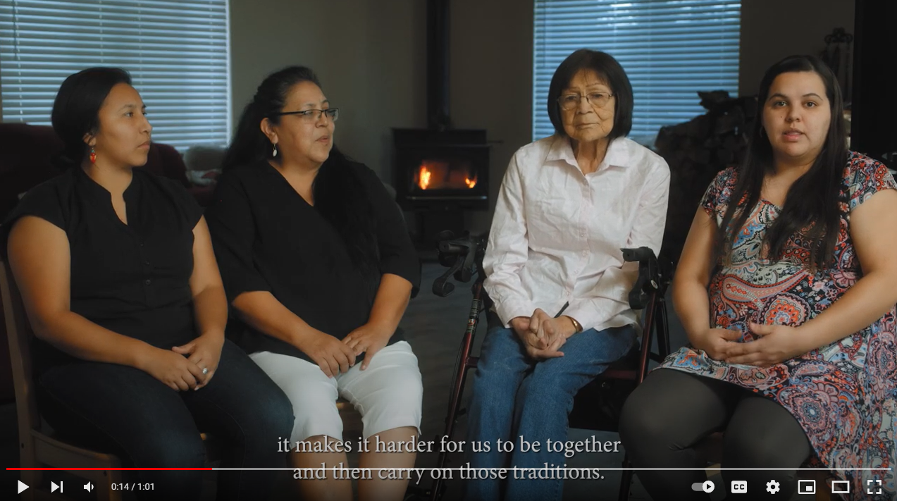 Four Native American women of different generations sit in a living room and speak to the camera