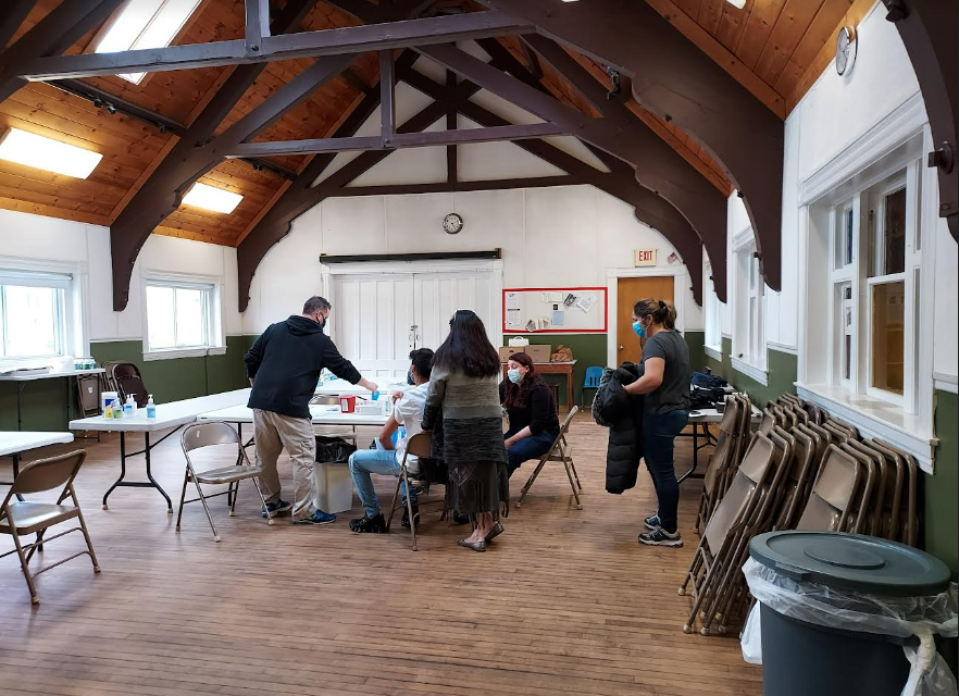 A group of people organize around a table for an event