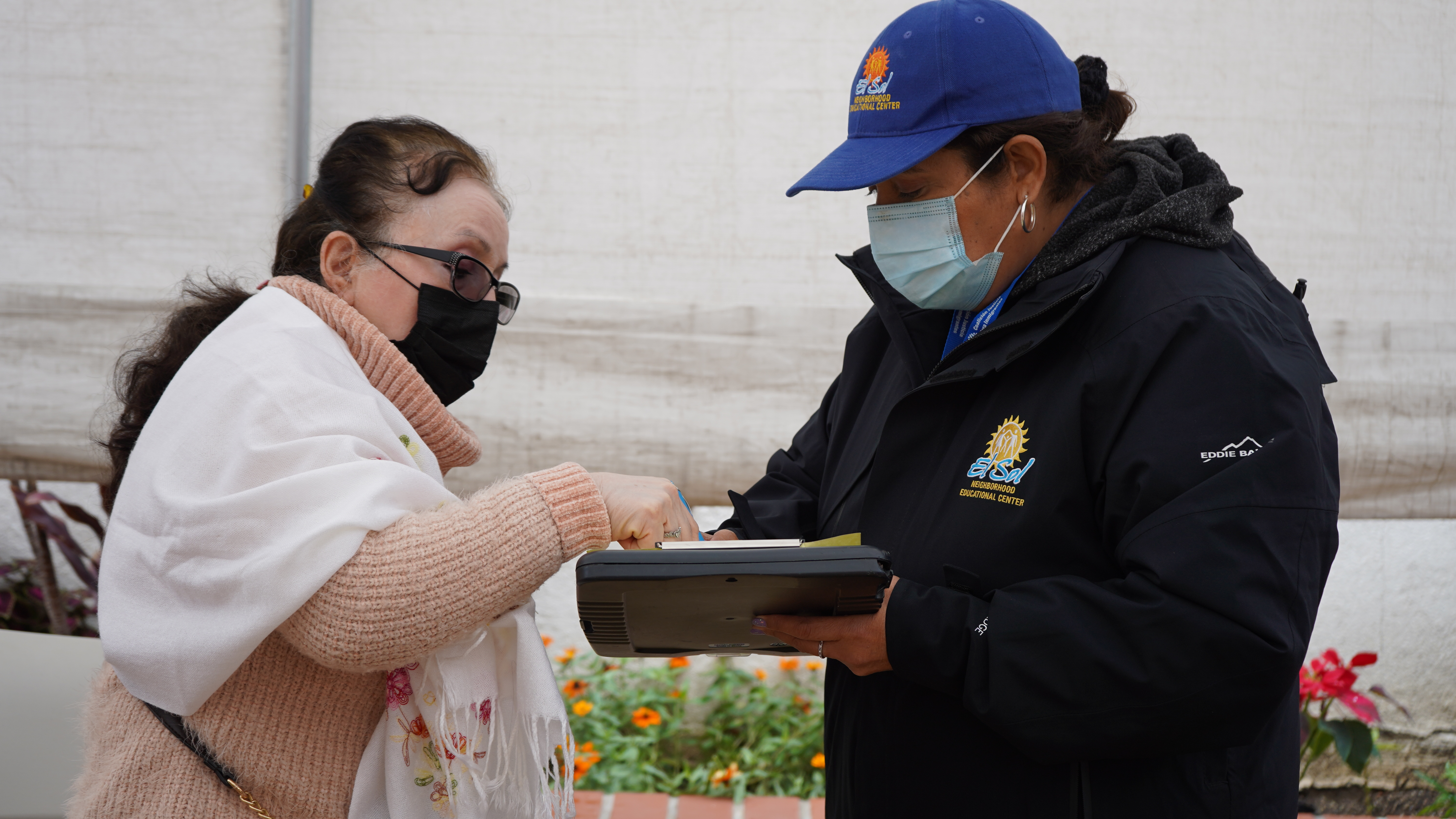 An El Sol community health worker assists a patron