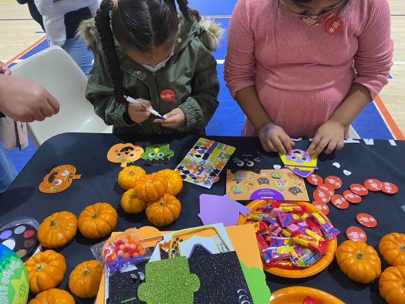 Children decorate Halloween themed stickers 