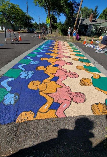 A colorful mural of people holding hands