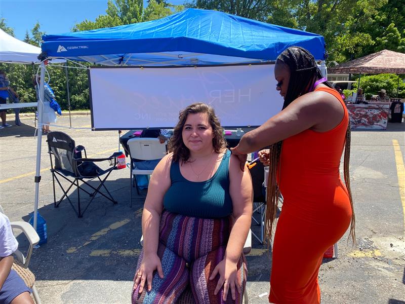 A woman gets vaccinated at a Juneteenth event for the Corner Health Center