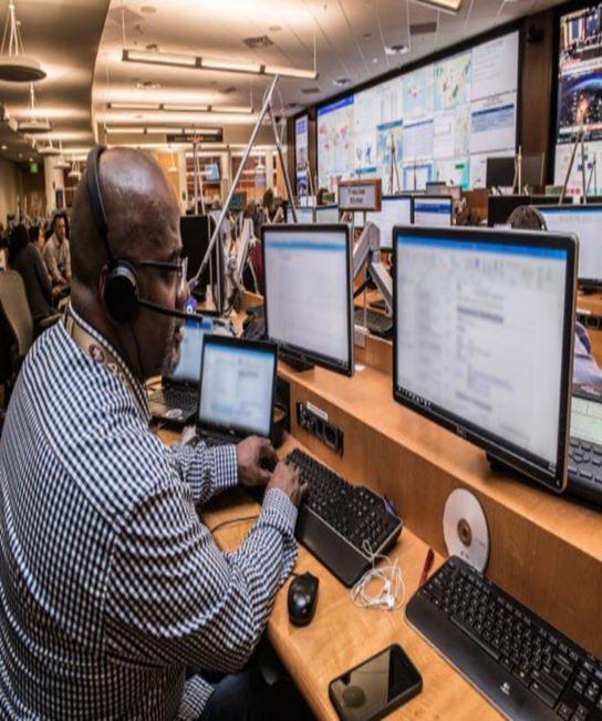 A person works at a computer workstation.