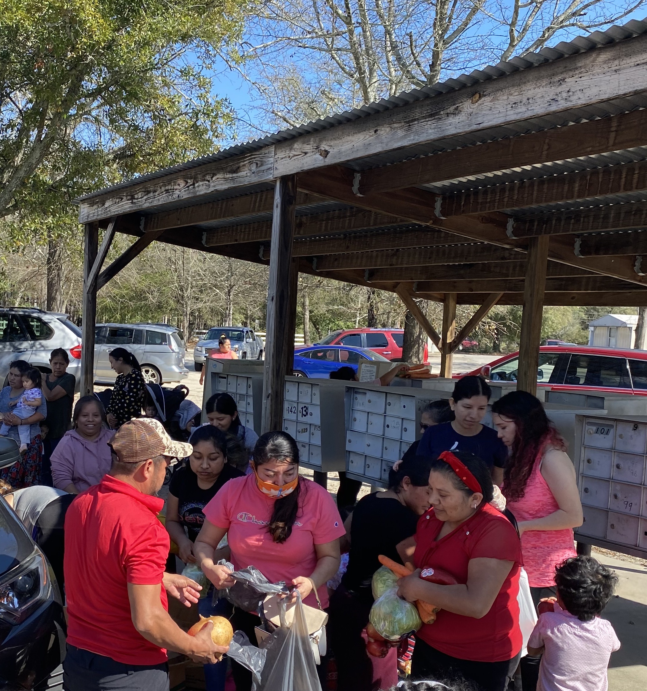 Community members attend a food giveaway