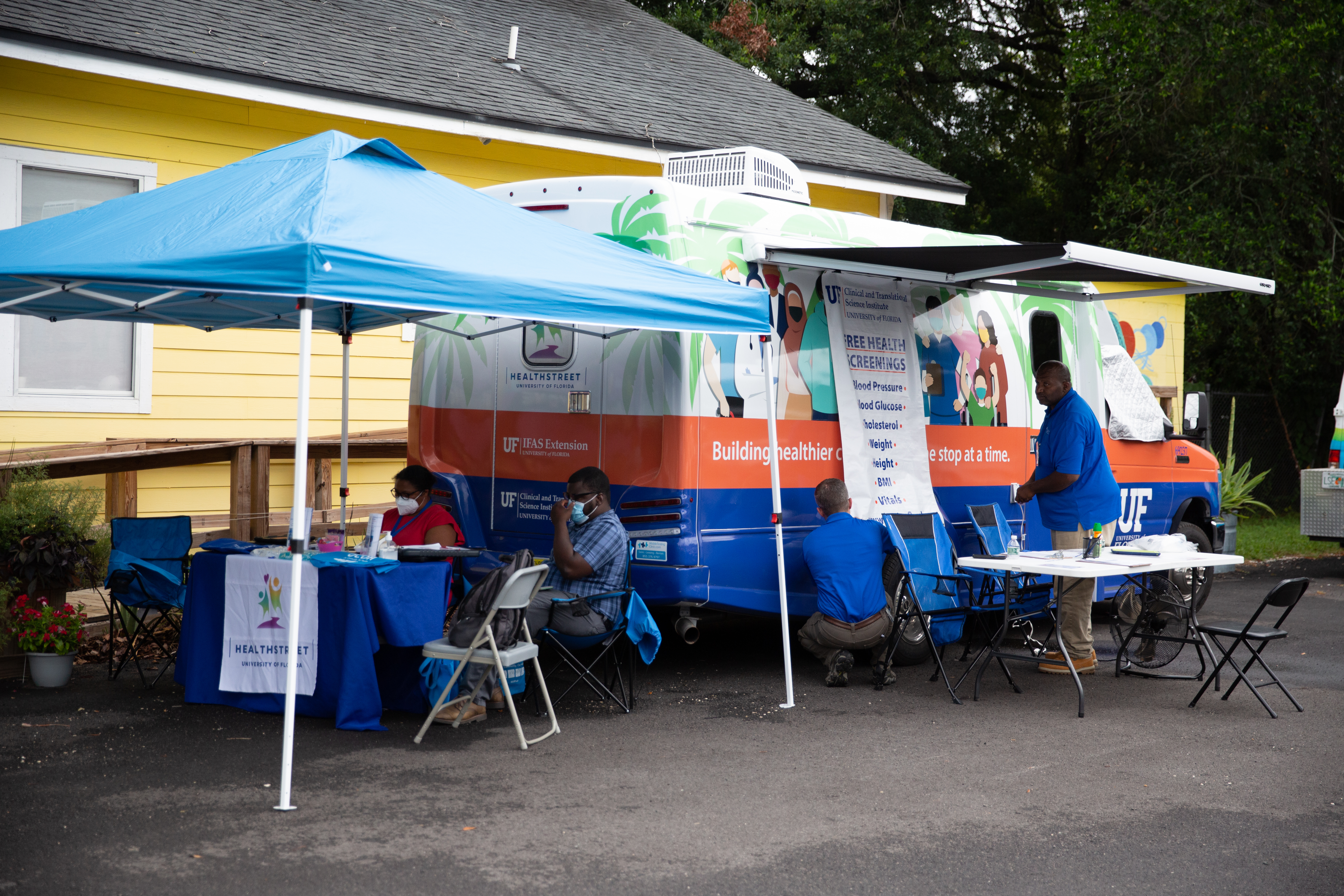 Workers staff a mobile clinic offering free health screenings.
