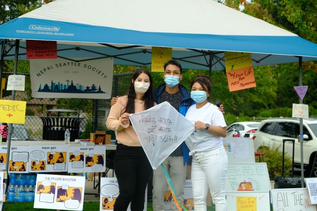 Nepal Seattle Society team poses with a kite. 