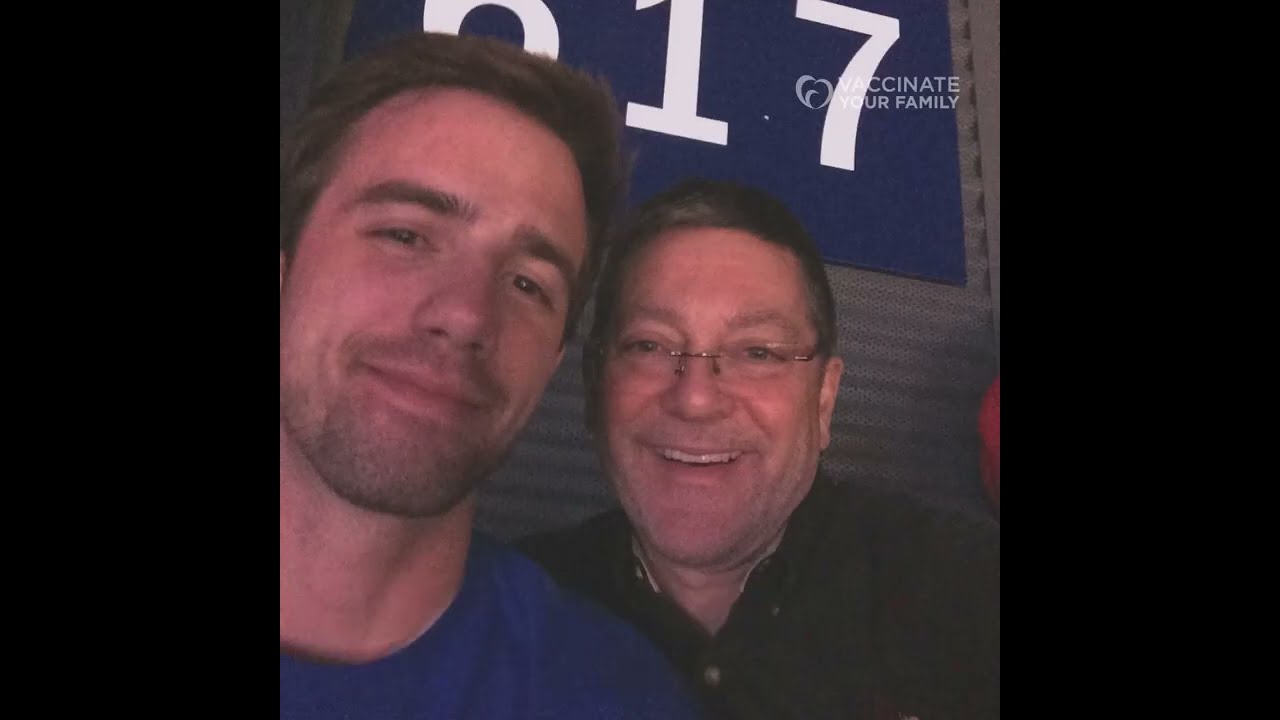 A young man and his dad smile in a "selfie" picture they took together 