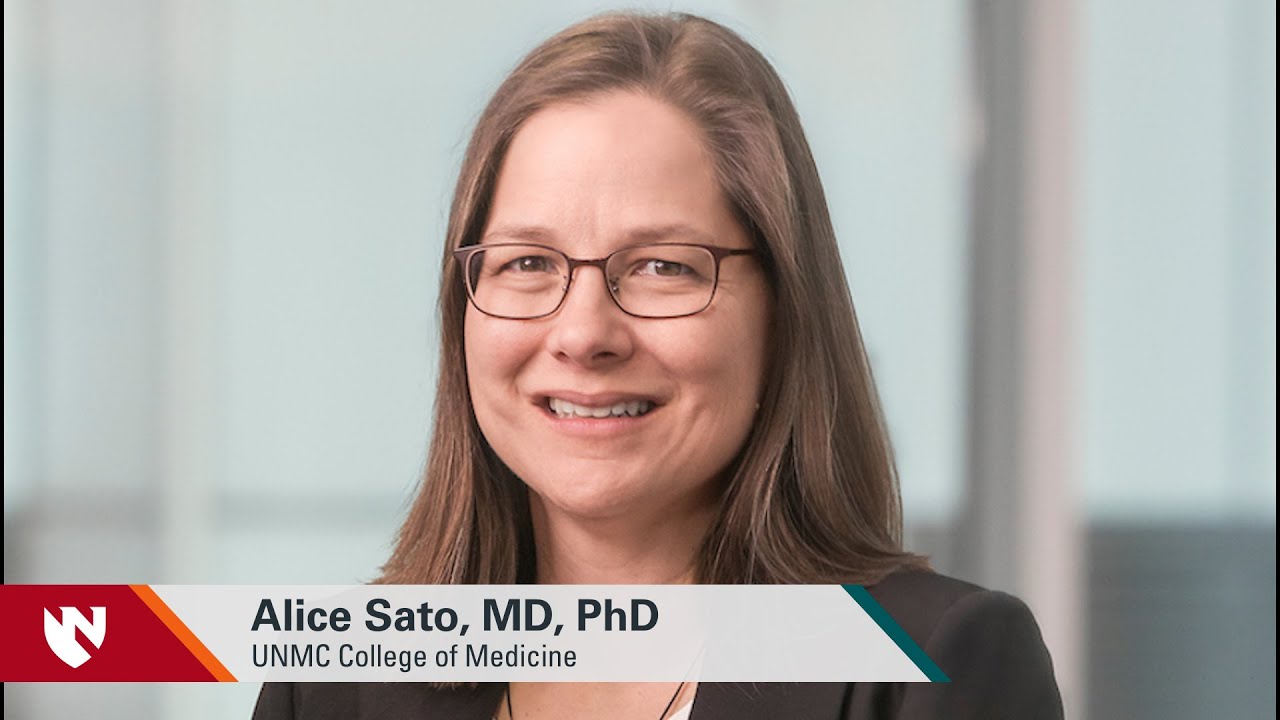 Image shows the speaker in the video, a White woman wearing glasses, and a banner at the bottom of the image with her title: Alice Sato, MD, PhD  