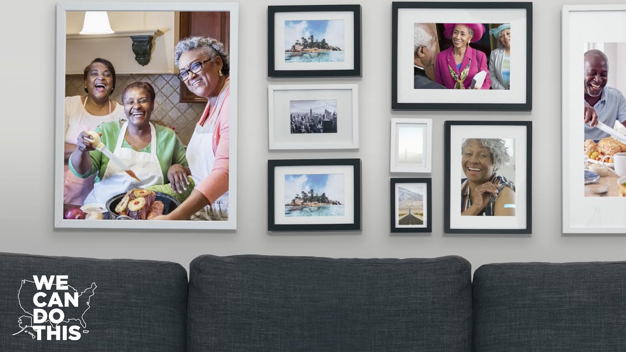A wall of framed pictures of family members and travel memories. 