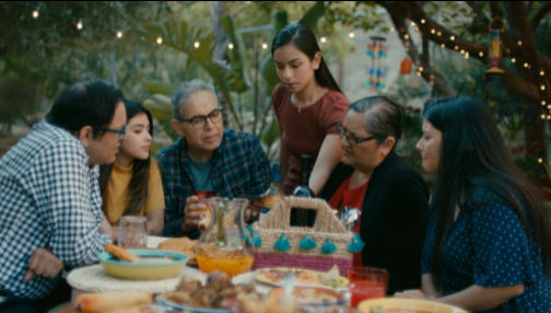 Scene from a video showing a family around a table