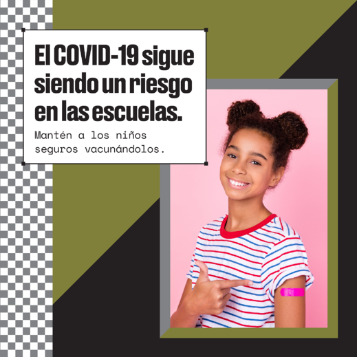 A Black girl smiles and points to an adhesive bandage on her arm. Spanish text reads, "COVID-19 remains a risk in schools. Keep kids safe by getting them vaccinated."