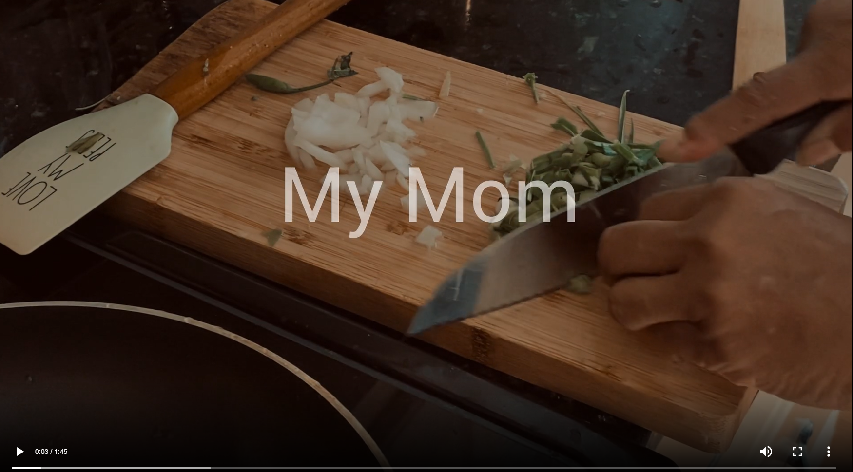 Afifah's mother's hands cutting up herbs for dinner. Title reads "My Mom"