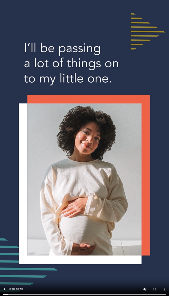 A Black pregnant woman smiles and places her hands over her stomach 