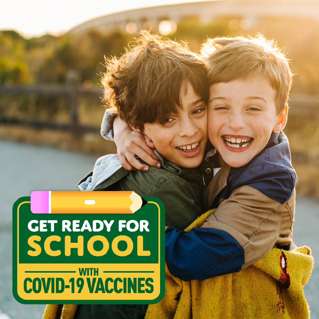 Two boys hug each other and smile. Logo in bottom left reads "Get ready for school with COVID-19 vaccines"