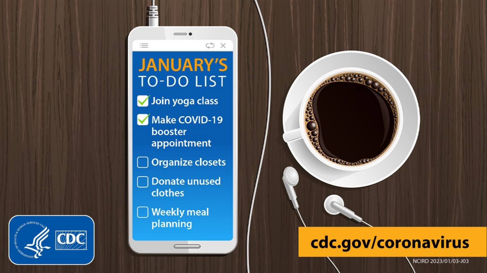 A to-do list for January appears on a smart phone next to a cup of coffee 