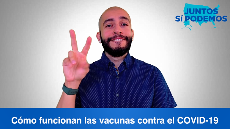 A man wearing a blue shirt uses sign language to explain how COVID-19 vaccines work