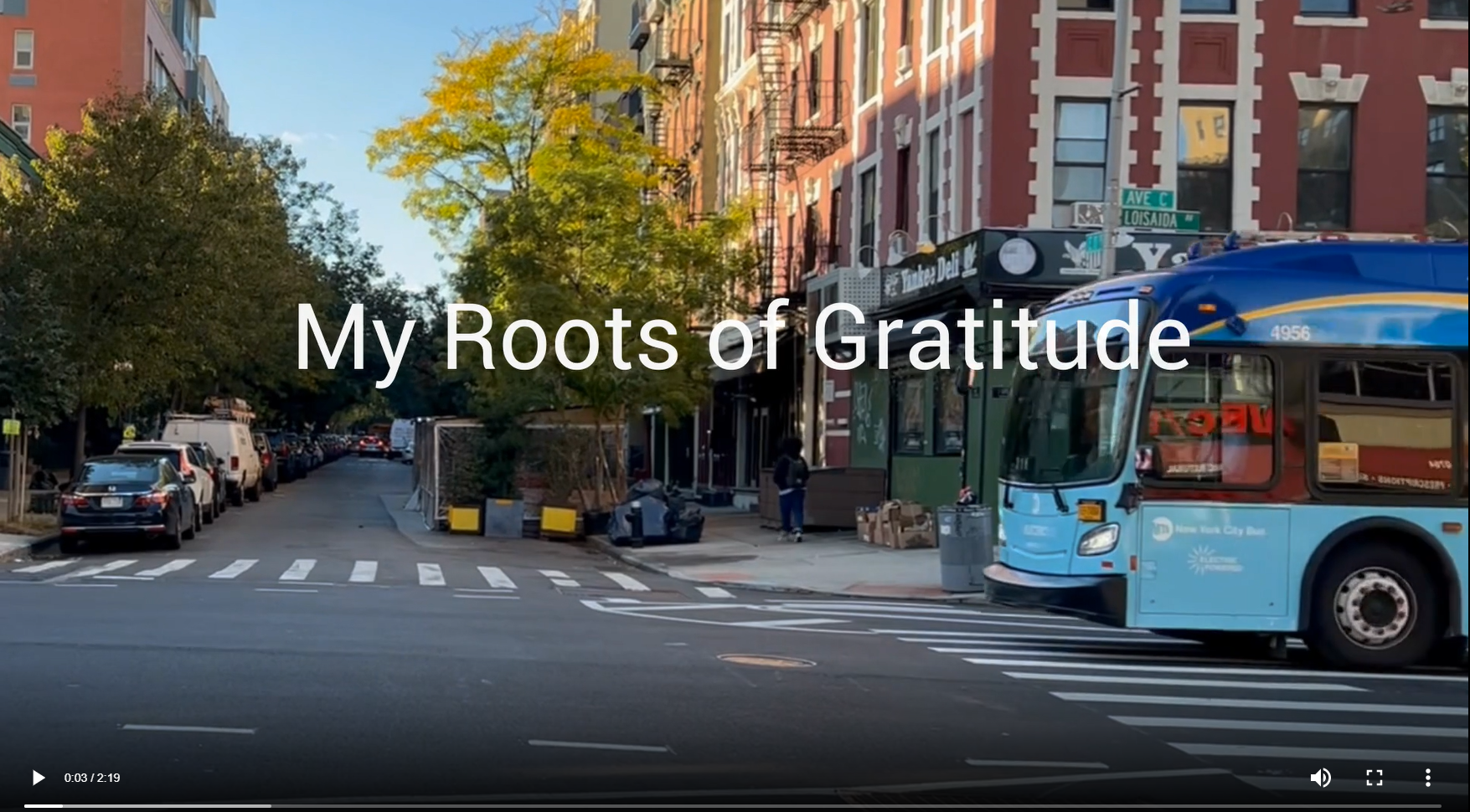 A street in New York City with cars and a bus. Title reads, "My Roots of Gratitude".