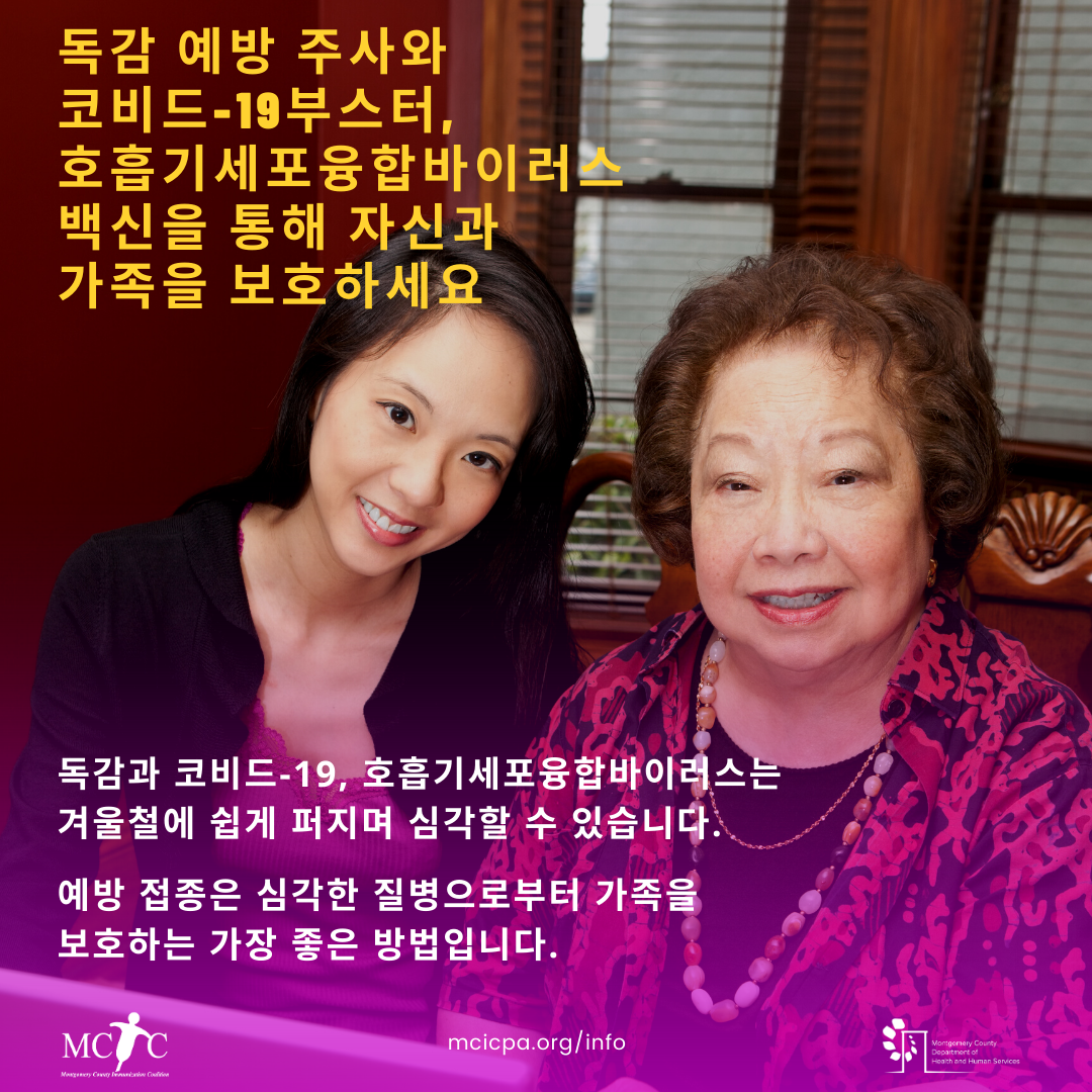 An Asian woman and her mother smile and sit at a table