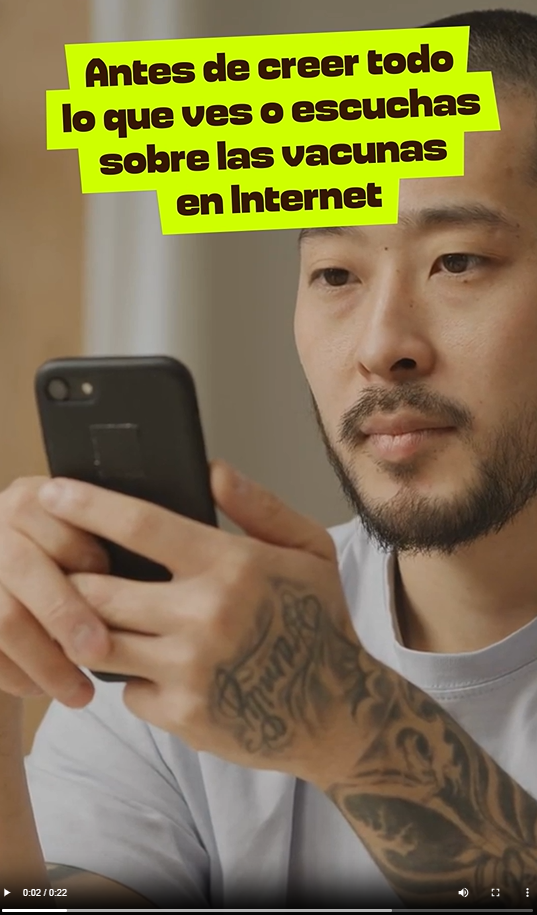 An Asian man looks at his phone