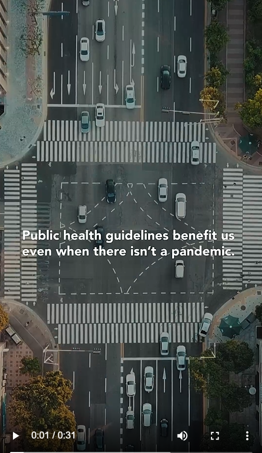 Image shows an aerial view of a busy intersection, with the words " Public health guidelines benefit us even when there isn't a pandemic" against the backdrop