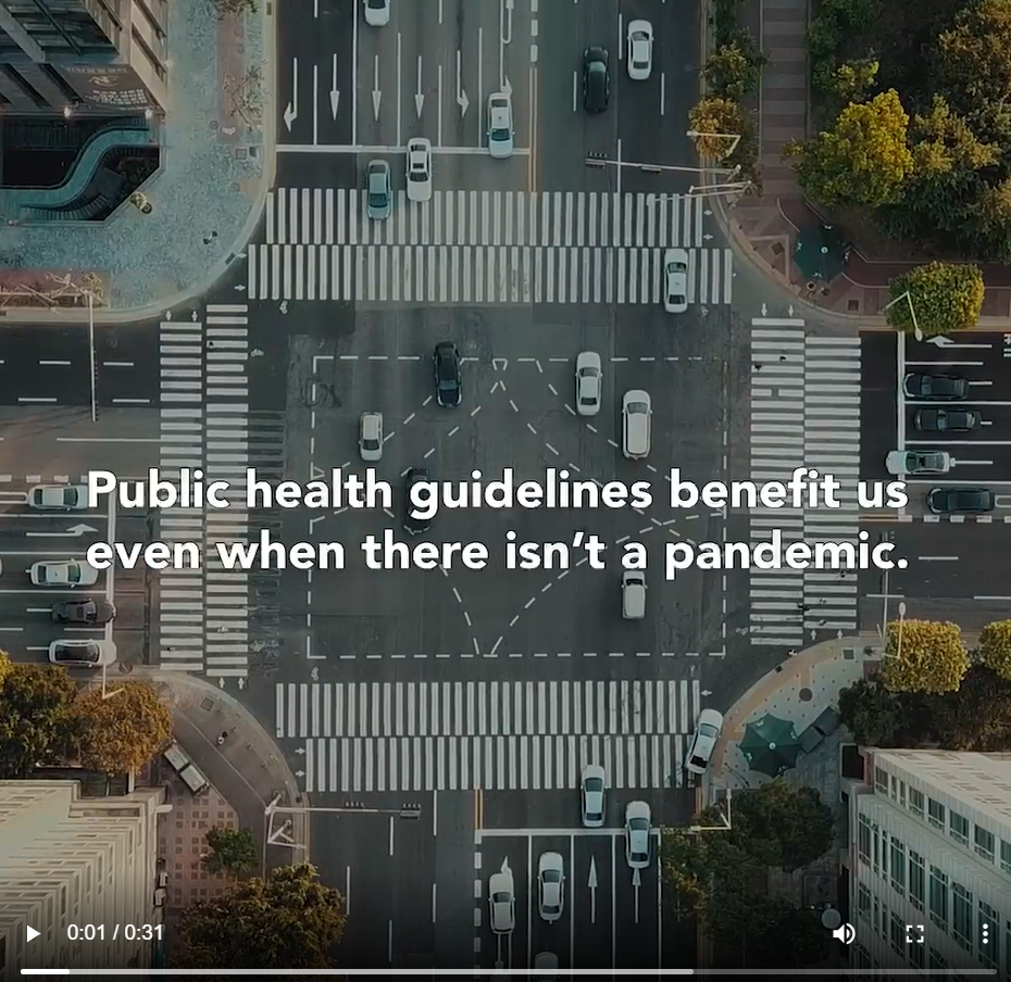 Image shows an aerial view of a busy intersection, with the words " Public health guidelines benefit us even when there isn't a pandemic" against the backdrop