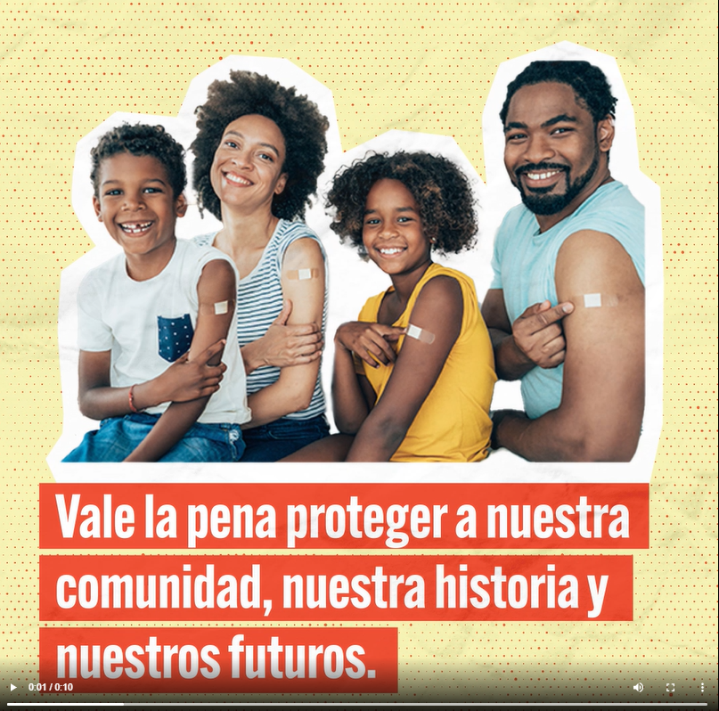 A Black family consisting of a mother, father, and a young girl and young boy smiles and shows adhesive bandages on their shoulders. Text reads in Spanish, "Our community, history, and futures are worth protecting."