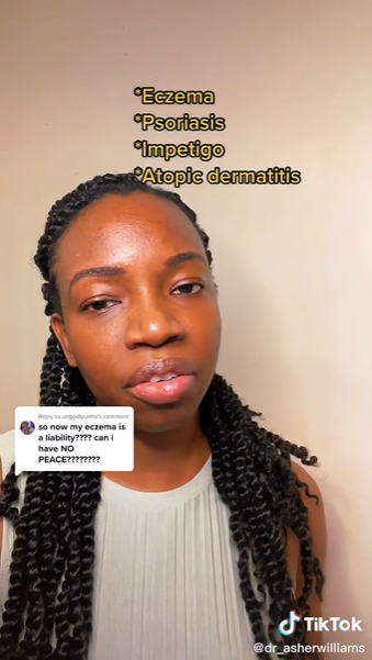 A Black woman wearing a gray shirt speaks to the camera. 