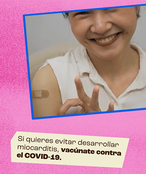An Asian woman smiles and proudly shows off a band-aid on her shoulder, while touching her thumb and index fingers together to form a circle and indicate approval.
