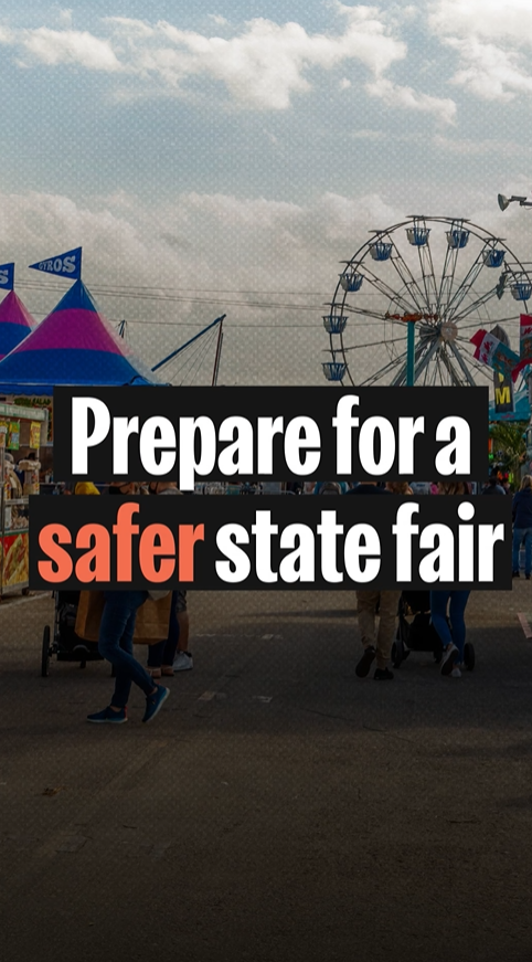 Video still shows text reading "prepare for a safer state fair" over an image of people walking and pushing strollers surrounded by carnival tents and a Ferris wheel.