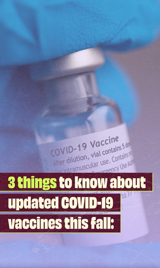 Video still shows a close-up image of a blue gloved hand holding a COVID-19 vaccine vial.