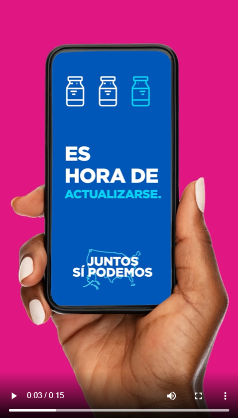 A person's hand holds a phone. The screen reads, "It's time for an update." in Spanish