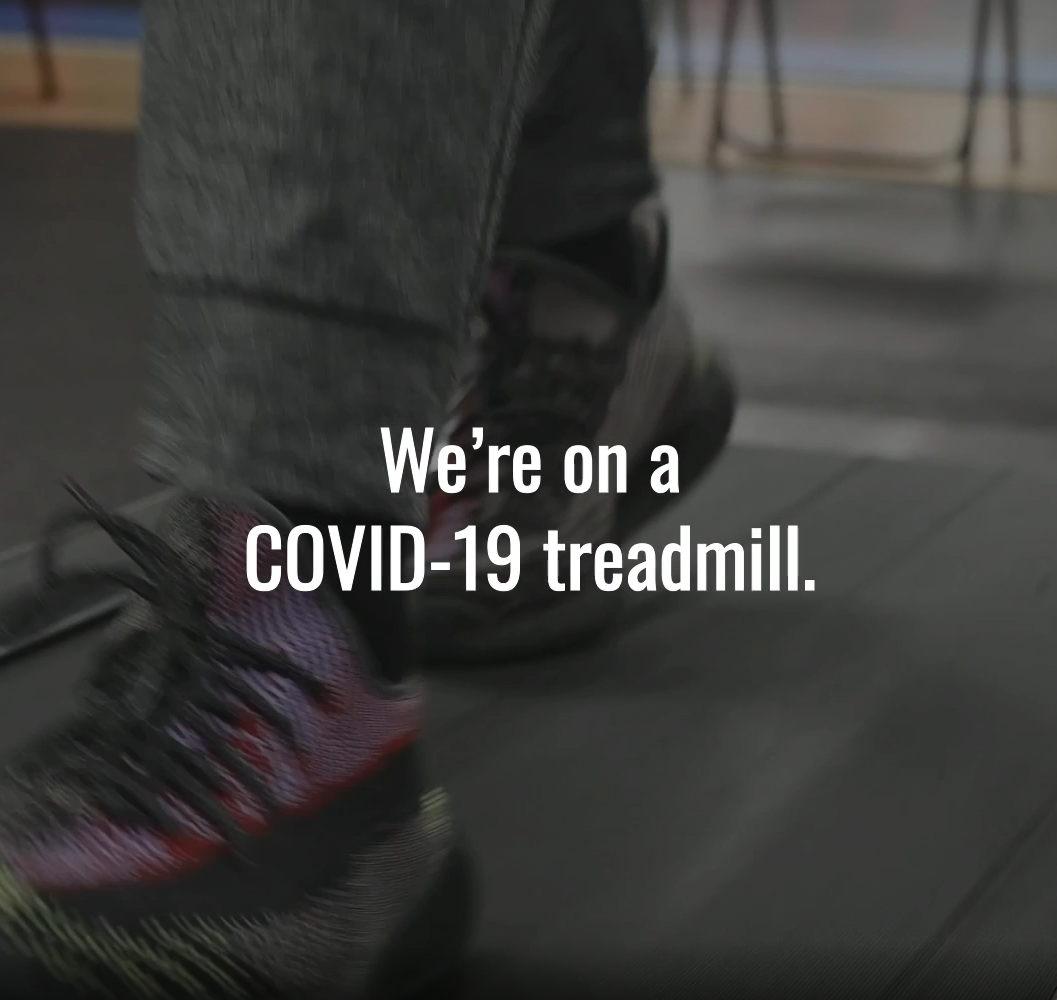 Image shows the lower leg and feet of someone wearing sneakers and walking on a treadmill