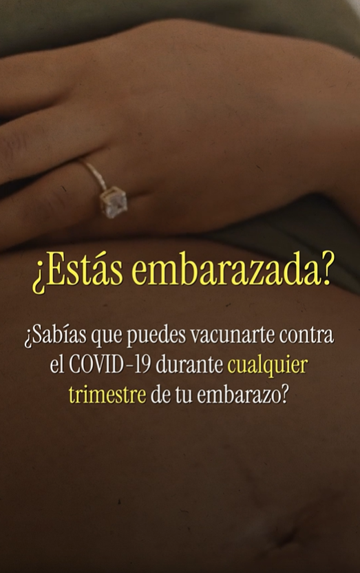 Close-up of a Black pregnant woman placing a hand on her stomach. Spanish text reads, "Pregnant? Did you know you can get vaccinated for COVID-19 during any trimester of your pregnancy?"