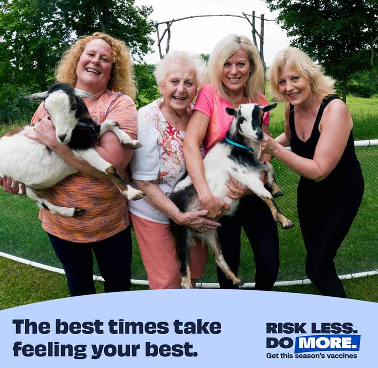 group of women with two carrying goats