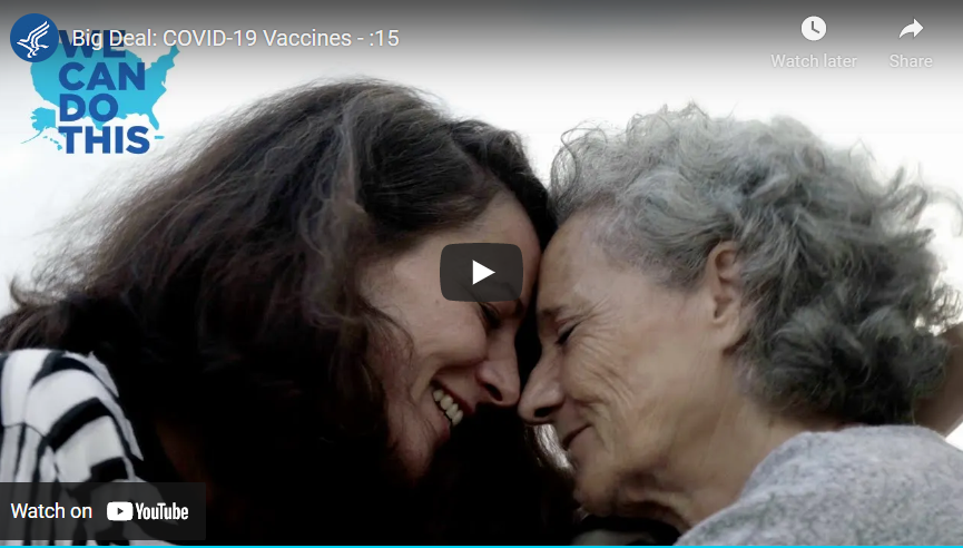 An adult woman and an older woman touch foreheads and smile at each other