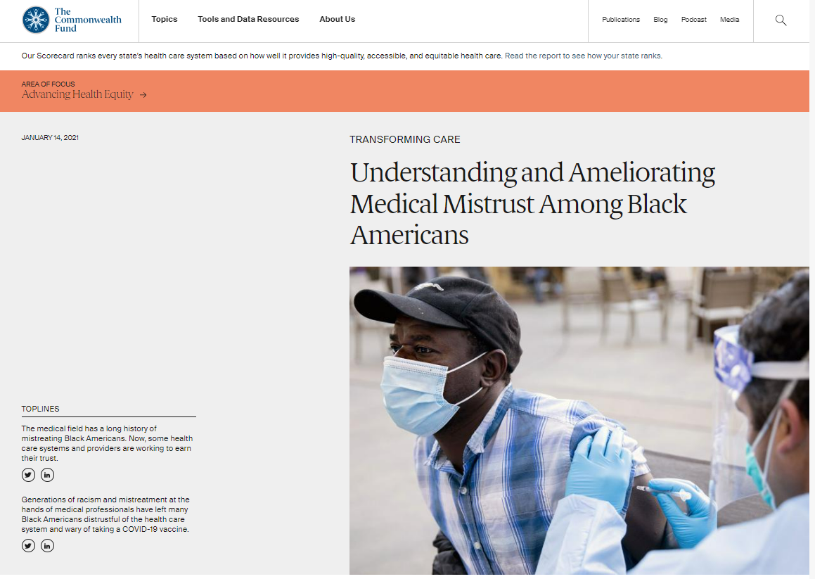 A Black man wearing a mask is vaccinated by a health care provider 