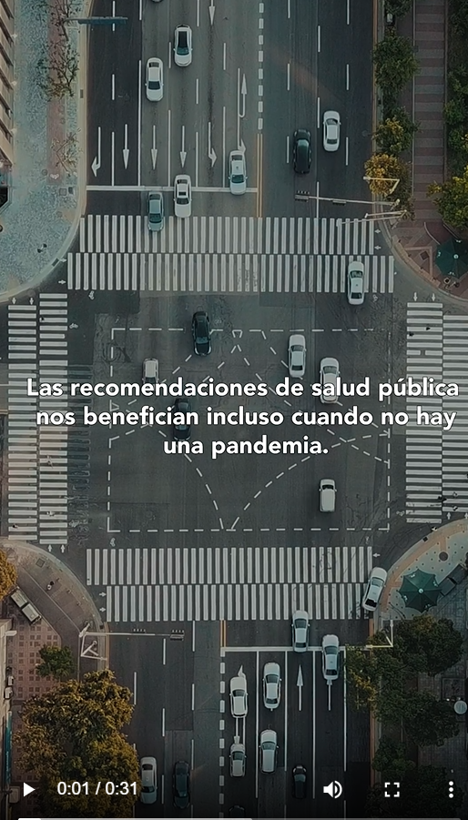 Image shows an aerial view of a busy intersection, with the words in Spanish" Public health guidelines benefit us even when there isn't a pandemic" against the backdrop