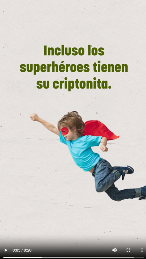 A young boy flies wearing a super hero cape and mask