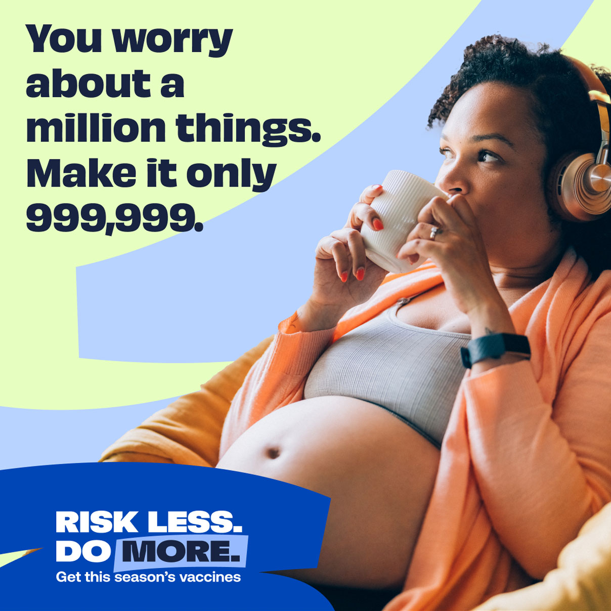 pregnant woman listening to headphones drinking from a mug