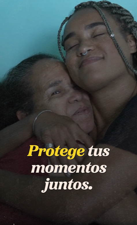 A Black Latina girl hugs her Latina grandmother