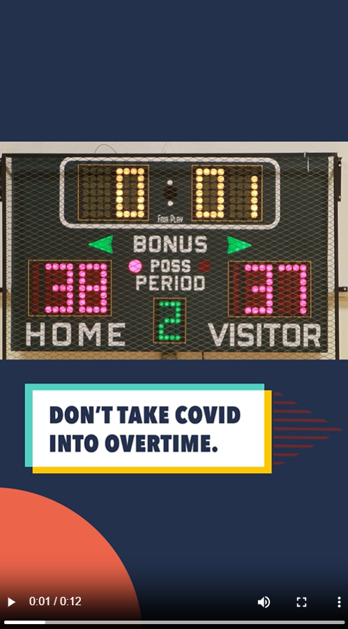 Image shows a scoreboard at a basketball game