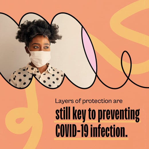 A Black woman wears a cloth mask. Text reads, "Layers of protection are still key to preventing COVID-19."