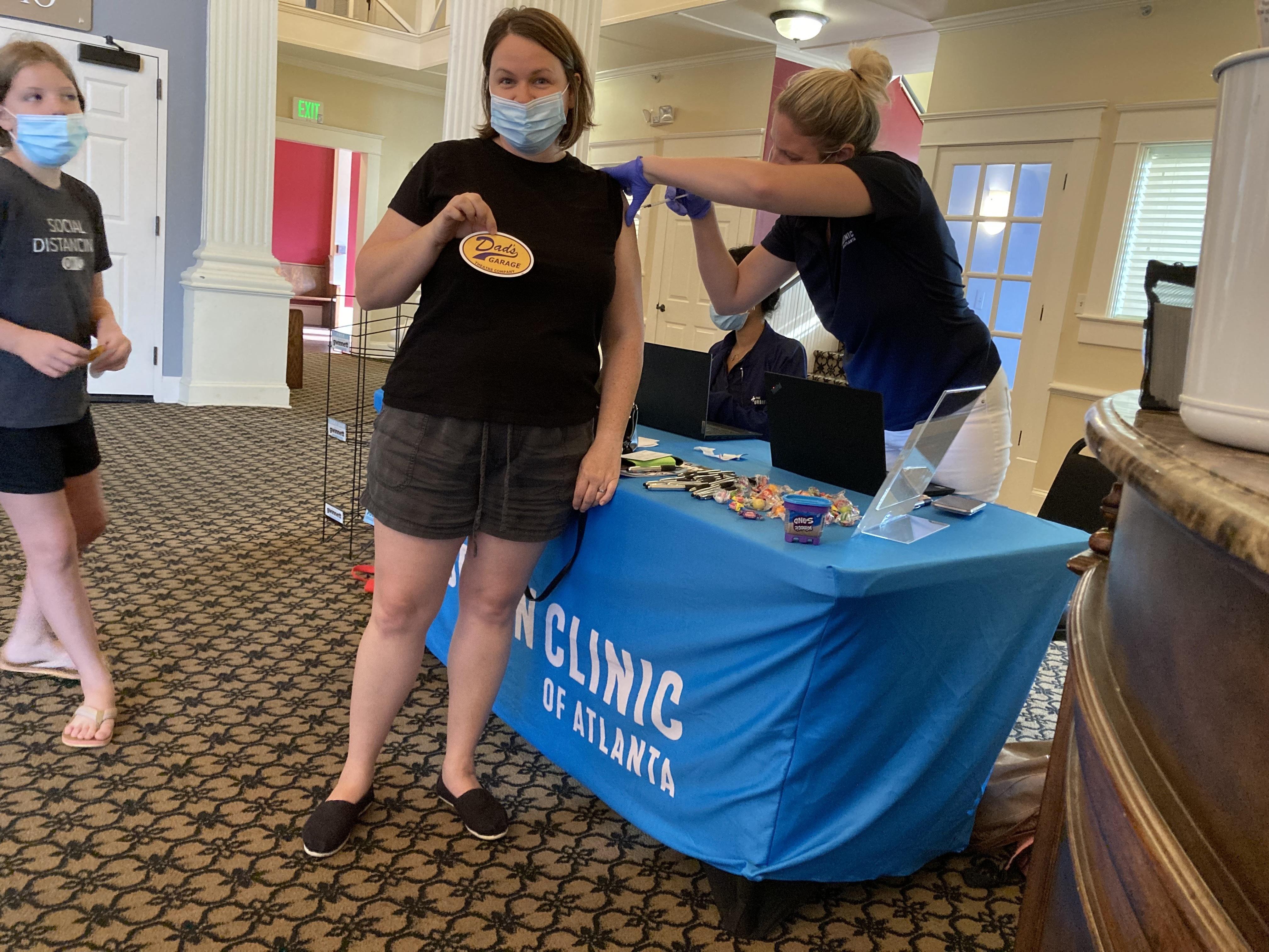 A group of women organize around a table for an event